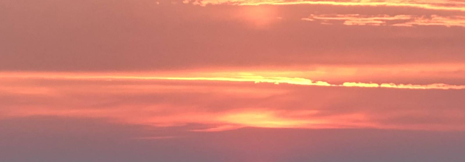 Sunset burning orange over open South Dakota grassland