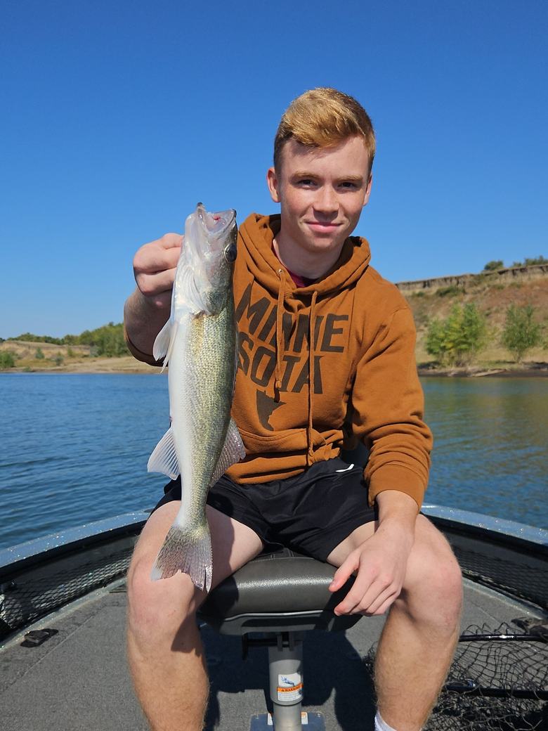 Angler with a Missouri River walleye aboard the boat