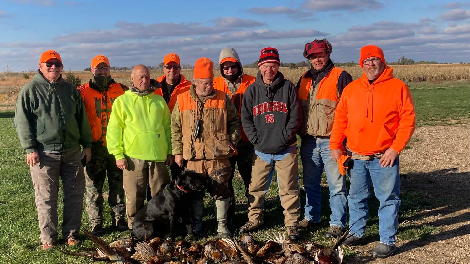 Full hunting party gathered in blaze orange at the end of a hunt