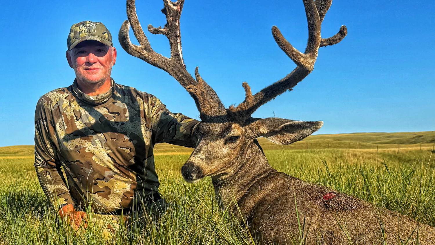 Hunter with a heavy-antlered South Dakota mule deer buck
