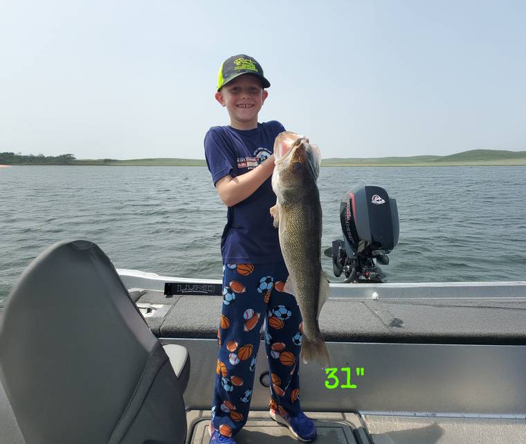 Young angler with a walleye caught on a guided Missouri River trip